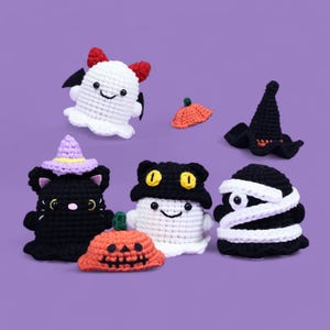 May include: A set of seven crocheted Halloween characters, including a ghost, a black cat, a mummy, a witch, and a pumpkin. The characters are all wearing different costumes and have different expressions.