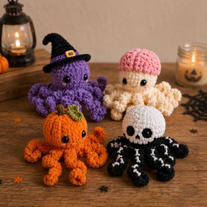 May include: Four crocheted octopus plushies with Halloween themes. One is purple with a black witch hat, one is cream with a pink brain cap, one is orange like a pumpkin with a green leaf, and one is black with a white skull head and bone details.