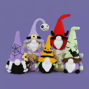 May include: A collection of six handmade crochet Halloween gnomes. Each gnome has a unique hat design, including a spiderweb, jack-o'-lantern, and devil horns. The gnomes are in various colors, such as purple, green, red, and yellow, with white beards and black bodies.