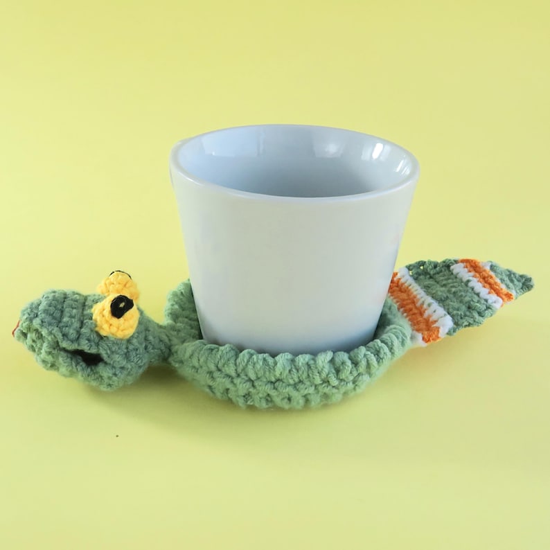 May include: A white ceramic mug with a black handle and the text "But First, Coffee" in a black, bold font. The mug is sitting on a white surface.