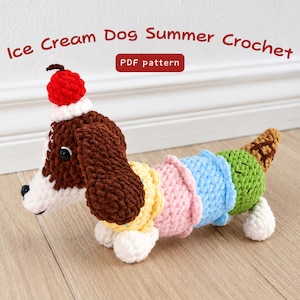 May include: A crochet dog toy featuring a brown and white head with a red cherry on top, and a body composed of yellow, pink, blue, and green ice cream scoops ending in a brown cone. The text reads Ice Cream Dog Summer Crochet PDF pattern.