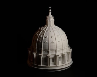 May include: A detailed, white architectural model of a domed structure, possibly a cathedral or basilica, against a black background. The model features intricate details, including columns, windows, and a cross atop the dome.