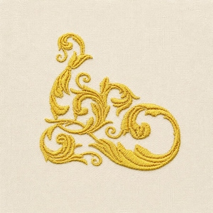 May include: A golden yellow embroidery design featuring an intricate, swirling filigree pattern with ornate leaf-like motifs. The embroidery is stitched onto a plain, light beige fabric background, creating a textured and detailed decorative element.