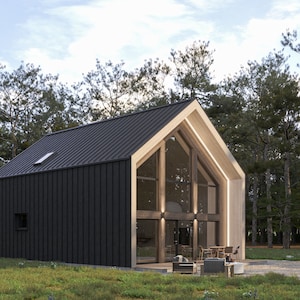 May include: Modern cabin with a black metal roof and dark siding. The A-frame structure features large glass windows and light wood trim. The cabin is surrounded by trees and a grassy area.