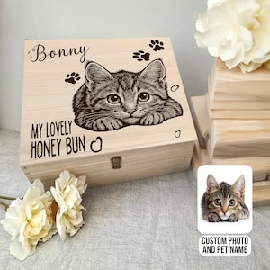 May include: A wooden box featuring a cat illustration, the name "Bonny", and the phrase "My Lovely Honey Bun". The design includes paw prints and hearts. A small photo of a cat is on the right with the text "Custom Photo and Pet Name".
