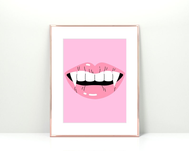 May include: A pink framed print with a pink cartoon mouth with fangs. The background is pink.