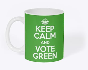 May include: White ceramic mug with a green background. The mug features the text "KEEP CALM AND VOTE GREEN" in white, with a white crown above the text. The mug has a white handle.