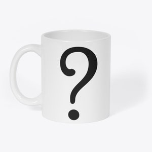 May include: White ceramic mug with a black question mark printed on the front.