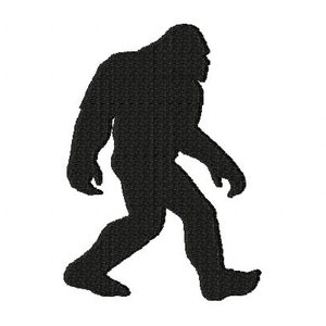 May include: Black silhouette of a Bigfoot creature walking to the left. The image shows the creature's full body, with a detailed texture effect. The background is plain white.