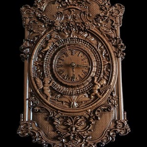 May include: Ornate wooden wall clock with a detailed, carved design. The clock features an oval face with Roman numerals and cherub figures. The clock's frame is intricately carved with floral and scrollwork patterns, showcasing a rich, brown color.