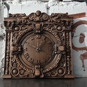 May include: An intricately carved wooden clock in shades of brown, featuring Roman numerals on its face. The clock's hands indicate a time of approximately 10:09. The clock has a rectangular shape with detailed decorative carvings.