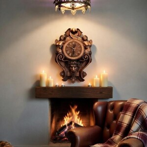 Detailed Victorian Gothic wall clock carved from dark ash wood featuring a grotesque mask and winged figures.