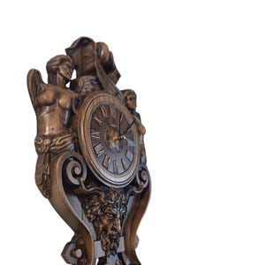 Side view of a 3D carved wooden clock showing the depth of the Gothic ornaments and ash wood texture.