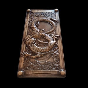 Puede incluir: Panel de madera tallada con un diseño de dragón. El dragón se muestra en una pose dinámica, con escamas y detalles intrincados. El panel tiene un acabado marrón oscuro y un borde decorativo con detalles redondeados.