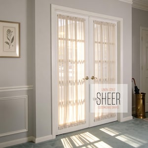 May include: Cream-colored semi-sheer linen-style drapes hanging on a white double door. The drapes are customizable and allow light to filter through. The text on the door reads "Semi-Sheer, Customizable Drapes".