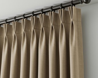 May include: A set of brown curtains with pleats hanging from a black metal curtain rod.