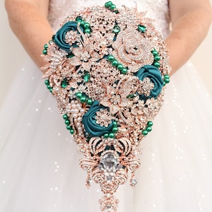 Emerald green brooch bouquet. Green wedding bouquet. Rose gold Cascade bridal bouquet. Jeweled bouquet.