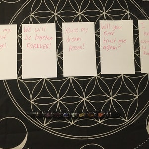 May include: Five white cards with pink handwritten messages on a black background. The messages are: "You're my biggest Craving!" "We will be together FOREVER!" "You're my dream Person!" "Will you ever trust me again?" "I don't know why Commitment is so difficult for me!"