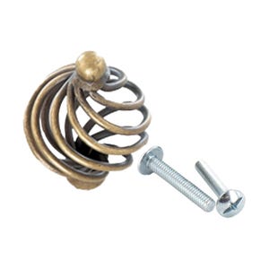May include: A gold-toned metal cabinet knob with a spiral design. The knob comes with two silver screws.
