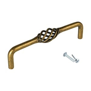 May include: A gold-toned metal cabinet pull with a decorative, twisted, cage-like design. The pull has a curved shape and comes with two screws.