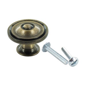 May include: Antique brass cabinet knob with a round, domed top and a raised ring around the edge. The knob comes with two screws.