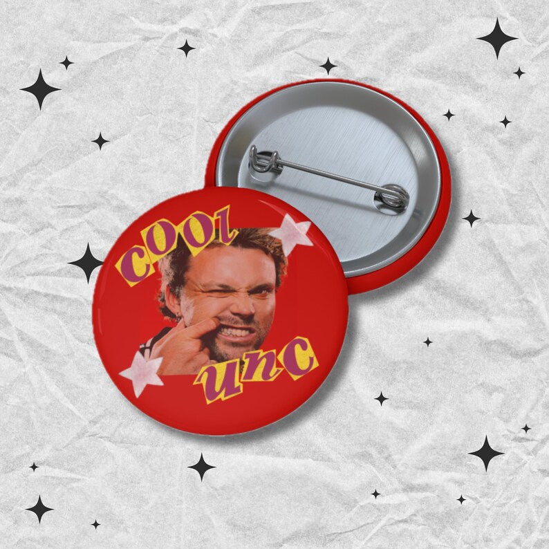 May include: Red button with a silver pin back. The button features a winking man with the words "cool unc" in yellow and pink. Two pink stars are on the button.
