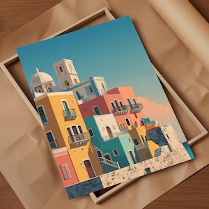 May include: A colorful art print featuring a coastal town with buildings in shades of yellow, pink, blue, and white. The buildings have balconies and are set against a clear blue sky. The print is displayed in a wooden frame.