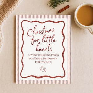 May include: A Christmas-themed book with a red and white striped border and the title "Christmas for little hearts" in cursive. The book includes text about advent coloring pages for kids and devotions for families. A cup of coffee is in the upper right corner.