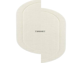 May include: Off-white, oval-shaped rug with rounded corners. The rug has a layered design, with a slightly raised border. The word "URBAN" is printed in black, centered on the rug. The rug is on a white background.