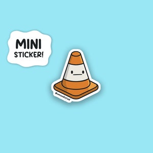 May include: A sticker of a cartoon traffic cone with a face. The cone is orange and white with a black outline. The sticker has the text "MINI STICKER!" and "@iamdadsfried" on it.