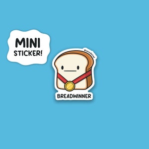 May include: A white bread sticker with a cartoon face wearing a red ribbon and a gold medal. The text "BREADWINNER" is below the bread and the text "@mommasdidit" is above the bread.