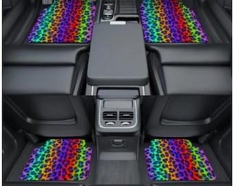 May include: Car floor mats with a vibrant rainbow leopard print. The set includes mats for the front and back seats of a vehicle. The mats feature a colorful design with red, orange, yellow, green, blue, and purple spots.