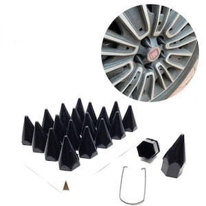 May include: A set of 20 black plastic lug nut covers with a pointed design. The covers are arranged in a grid pattern on a white surface. A single lug nut cover is shown separately, along with a metal ring.