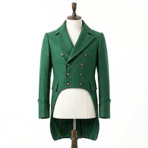 May include: A green double-breasted tailcoat with gold-colored buttons. The coat has a notched lapel, long sleeves with buttoned cuffs, and a split tail in the back. The coat is displayed on a mannequin.
