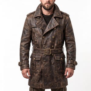 May include: A brown leather trench coat with a double-breasted design. The coat features a wide collar, a belt with a large buckle, and multiple pockets. The leather has a distressed, vintage appearance, with brass-colored buttons and buckles.