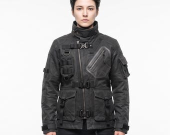 May include: A black tactical jacket featuring a high collar, an asymmetrical front zipper, and multiple utility pockets. The garment includes adjustable straps with plastic buckles, D-rings, and reinforced panels on the sleeves and chest area.