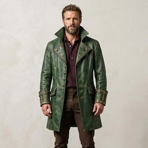 May include: A long, forest green coat featuring a high collar, structured lapels, and a double row of brass-toned buttons. The coat includes decorative stitching along the cuffs and front panels, worn over a dark maroon shirt and brown trousers.