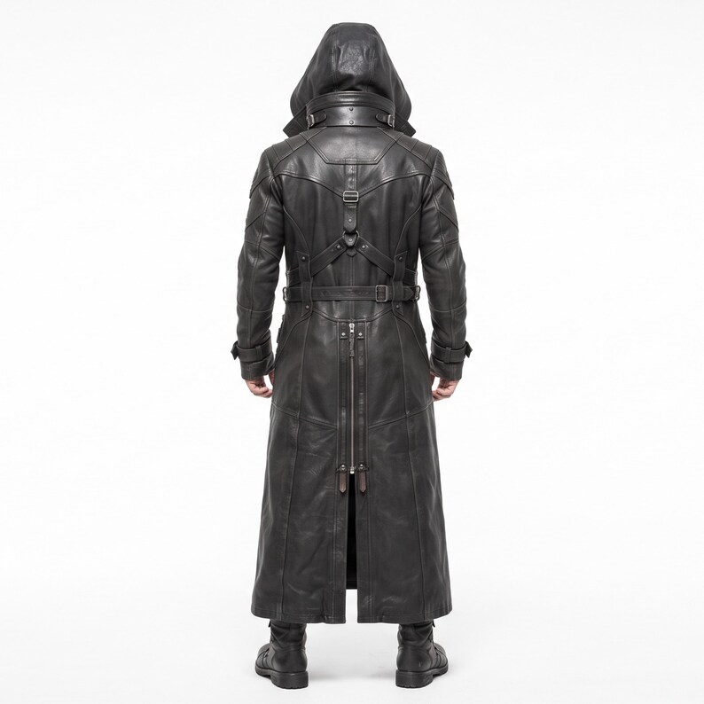 May include: A black long coat featuring a hood, a high collar with buckle straps, and a harness-style back detail. The garment includes a vertical back zipper, long sleeves with buckled cuffs, and a structured design with visible seam lines.