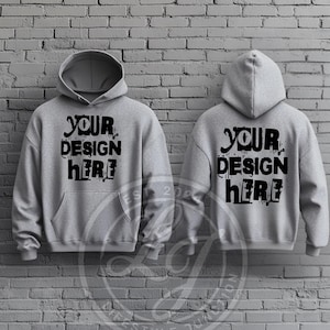 以下が含まれることがあります： 前面と後ろに黒で「Your Design Here」と印刷された灰色のフード付きスウェットシャツ2枚