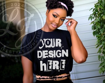 May include: A black t-shirt with the text "YOUR DESIGN HERE" in white, distressed lettering. The shirt is being worn by a person with dark skin and curly hair.