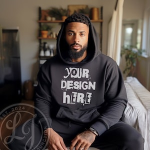 May include: A black hooded sweatshirt with the text "YOUR DESIGN HERE" printed in white on the front.