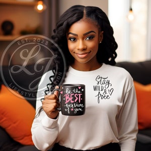 May include: A black coffee mug with a pink and white design that says "be the BEST version of you" and "Stay Wild & Free".