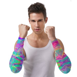 May include: A person wearing a white tank top with colorful arm sleeves. The sleeves have a geometric pattern with shades of pink, blue, green, and yellow.