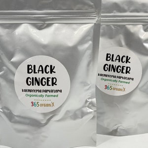 May include: Two silver pouches with white labels that say "Black Ginger" in black text. The labels also include the text "kaempferia parviflora" and "Organically Farmed" in black text. The labels also include the text "365 organiX" in green, yellow, red, and blue text.