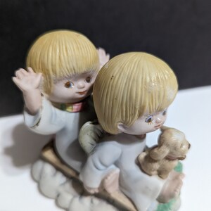 Precious Angel children with puppy on a sled figurine. vintage look. collectors. winter scene. any occassion gift or collectable.