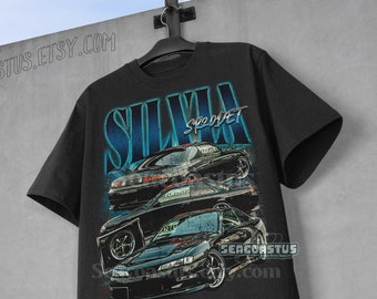 May include: Black t-shirt with a graphic print of three black Nissan Silvia cars. The text "SILVIA" and "SPORT" is printed in blue on the shirt.