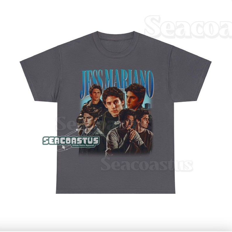 May include: A gray t-shirt with a vintage-style graphic of Jess Mariano from the TV show Gilmore Girls. The graphic features a collage of images of Jess Mariano, with the text "Jess Mariano" in a blue and white font.