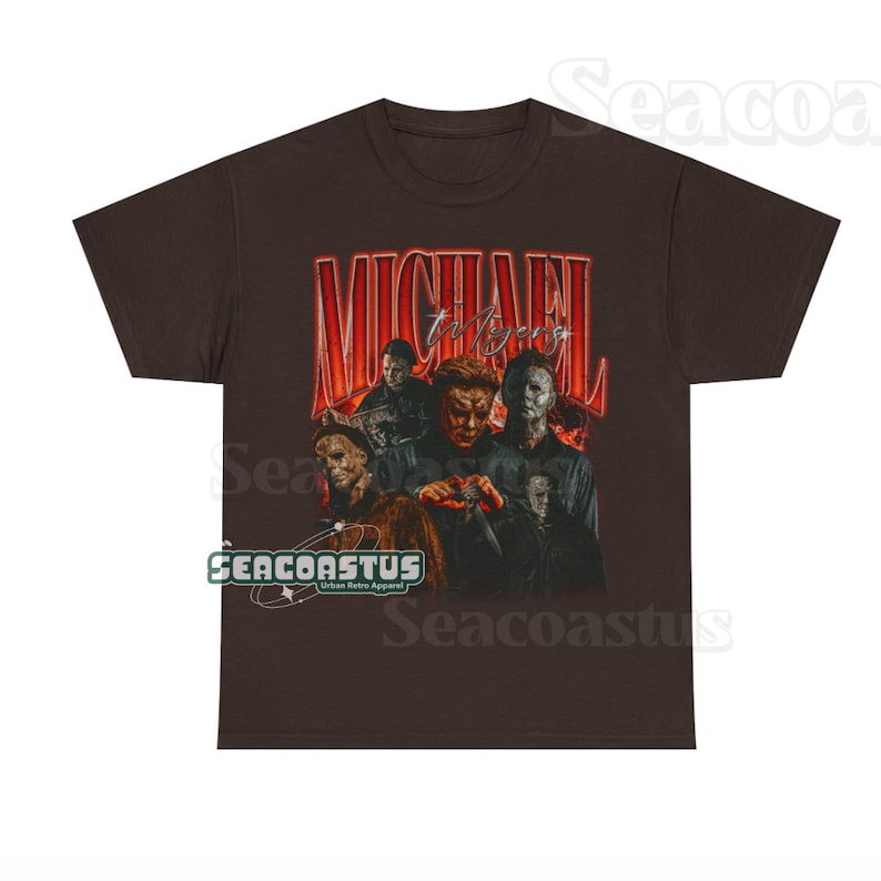 May include: A brown t-shirt with a vintage-style graphic of Michael Myers from the Halloween franchise. The graphic features a collage of different images of Michael Myers, including his mask, knife, and other iconic elements from the films. The text "MICHAEL Myers" is written in a bold, red font above the graphic.