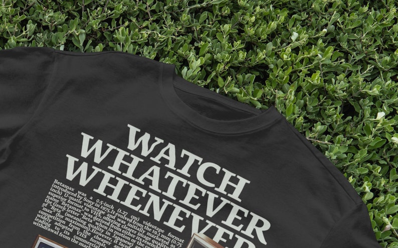 May include: Black t-shirt with white text that reads "WATCH WHATEVER WHENEVER".