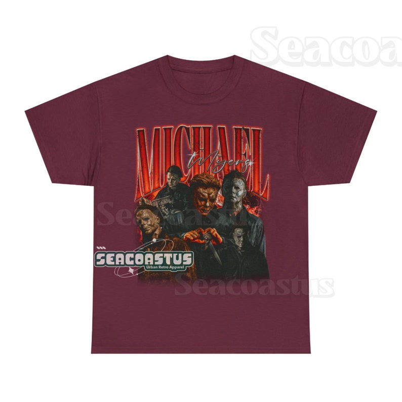 May include: A maroon t-shirt with a vintage-style graphic of Michael Myers from the Halloween franchise. The graphic features multiple versions of Michael Myers from different movies in the franchise. The text "MICHAEL Myers" is written in a large, bold font above the graphic.